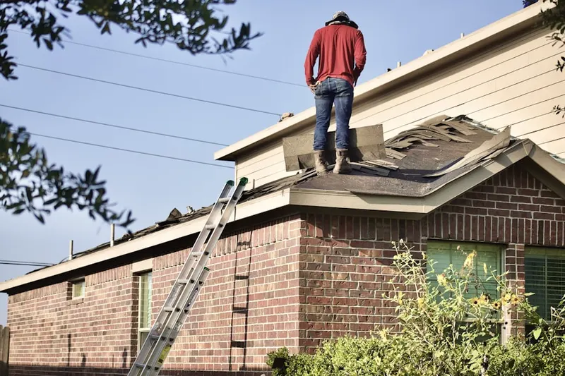 Professional roofer working on a residential roof in Eastanollee